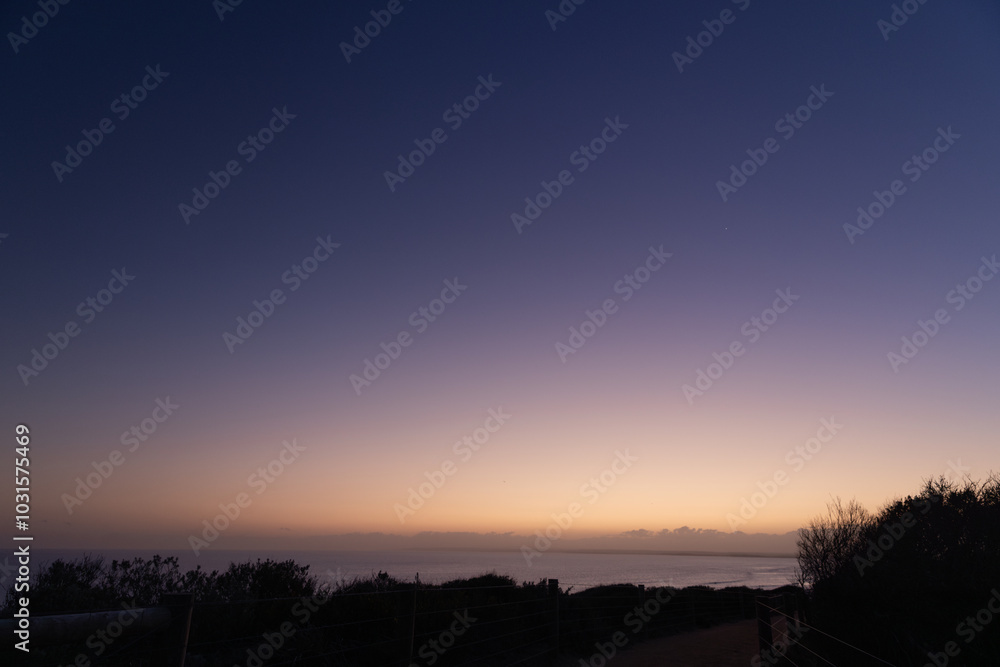 Twilight purple sunset over silhouette Coastal Horizon Twilight purple sunset over silhouette Coastal Horizon