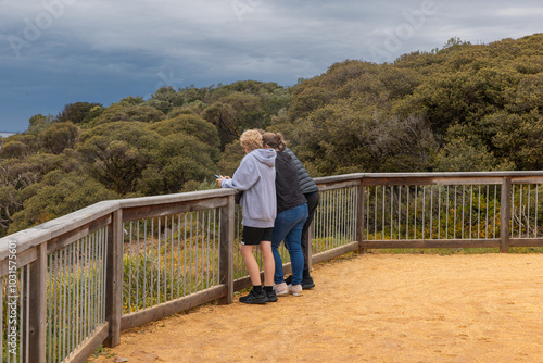 Three people observing the view from a lookout in Barwon Heads photo