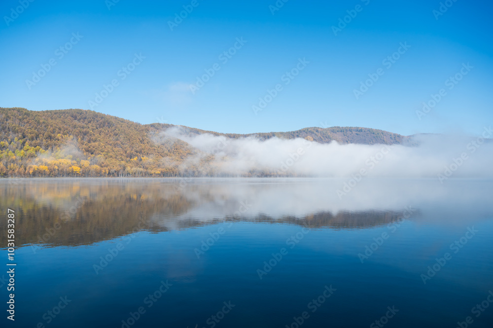 Early morning views of the lake and the mist on the surface of the water Early morning views of the lake and the mist on the surface of the water