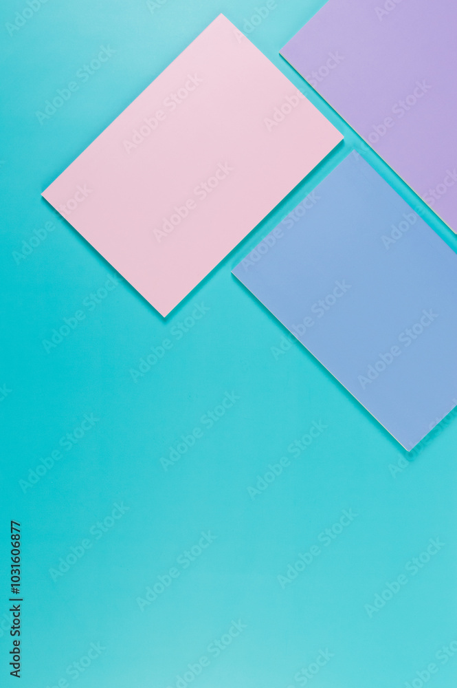 Top view of pink, purple and blue notebooks on blue background. Pink, yellow and blue pens, school, office wallpaper. Flat lay, copy space. Top view of pink, purple and blue notebooks on blue background. Pink, yellow and blue pens, school, office wallpaper. Flat lay, copy space.