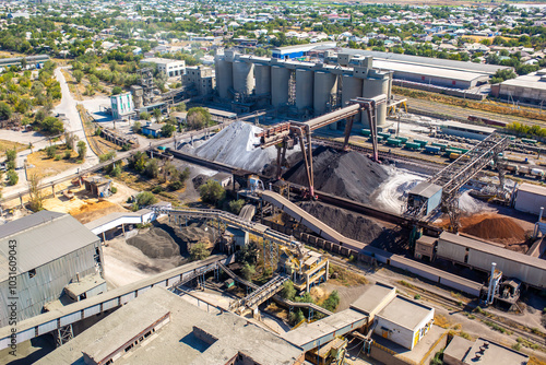 Cement plant view from above. Workshops and compressors, equipment, metallurgy. Technological work on cement production. Industrial production on a large scale.