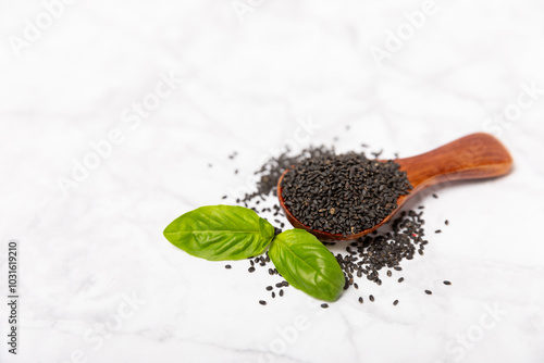 Basil seeds on textured wooden background. Close-up. Superfood. Ocimum basilicum. Organic basil seeds. selasih. Space for text. Copy space. photo