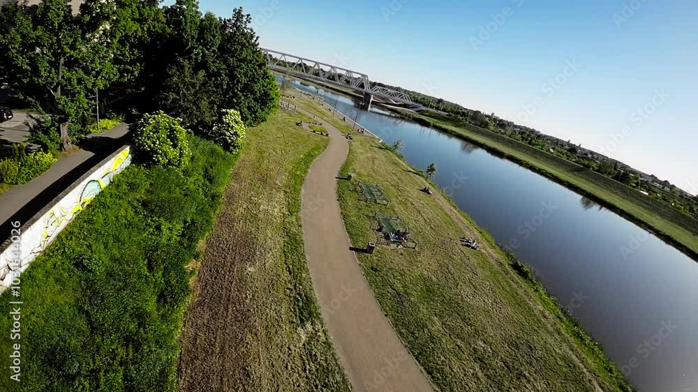A serene aerial view of Opole, Poland, showcasing the picturesque landscape and tranquil atmosphere of the city. The video features lush green parks, a meandering river, and charming residential areas A serene aerial view of Opole, Poland, showcasing the picturesque landscape and tranquil atmosphere of the city. The video features lush green parks, a meandering river, and charming residential areas