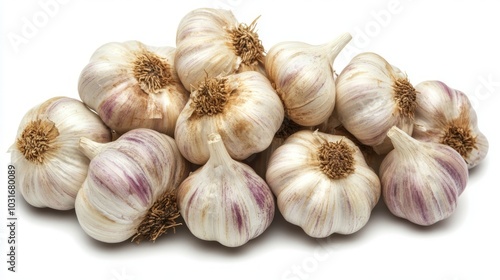 A pile of fresh garlic bulbs with purple stripes isolated on a white background.