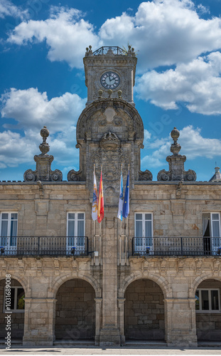 Arcada, fachada y torre del reloj en el ayuntamiento o concello de Lugo, España photo