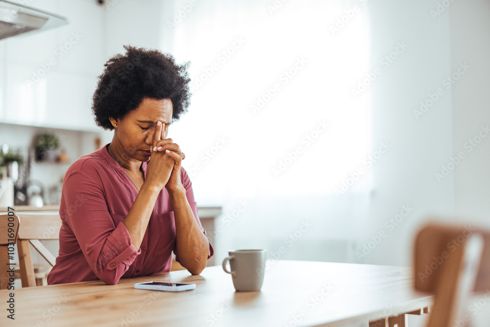 Stressed Woman Reflecting at Home With Hands Clasped Stressed Woman Reflecting at Home With Hands Clasped