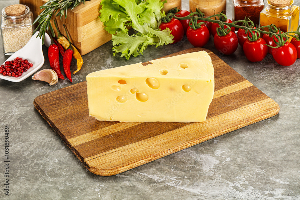 Swiss Maasdam cheese triangle over board