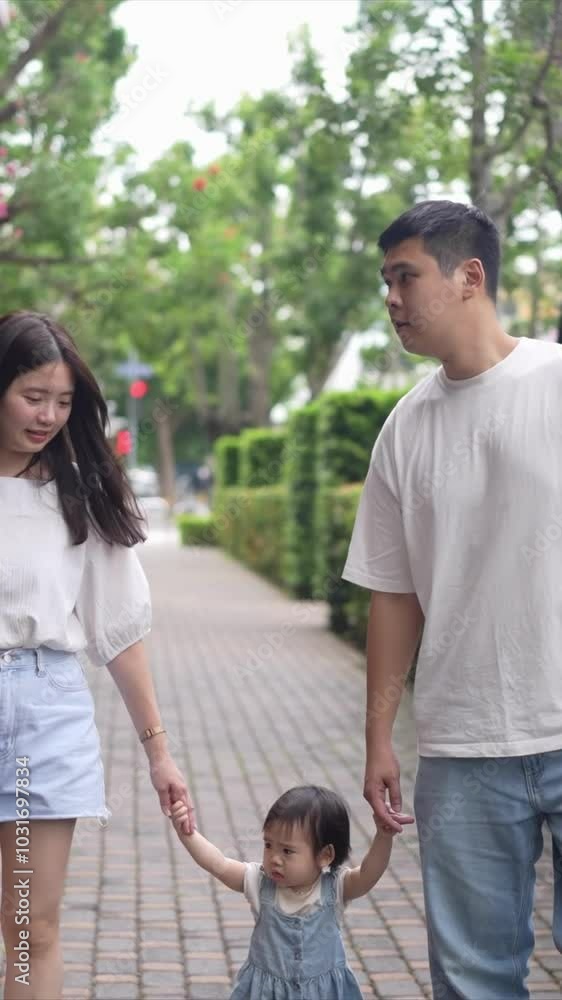 A Taiwanese family, consisting of a father in his 30s, a mother in her 20s, and their 1-year-old daughter, are walking apartment in Taichung City, Taiwan.Realtime, Vertical Video. A Taiwanese family, consisting of a father in his 30s, a mother in her 20s, and their 1-year-old daughter, are walking apartment in Taichung City, Taiwan.Realtime, Vertical Video.