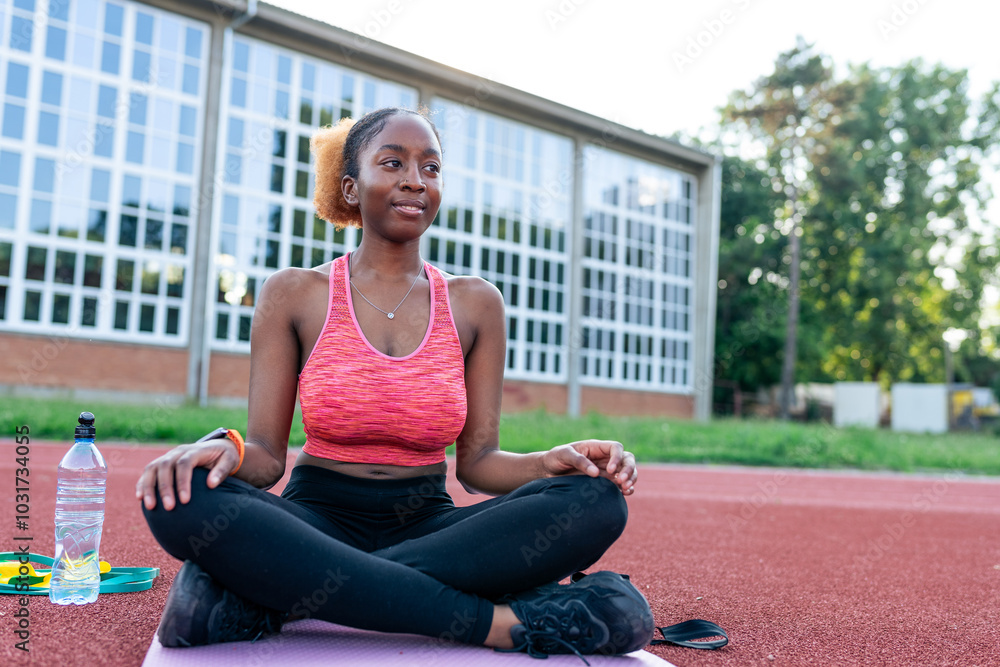 In her workout zone, the black woman showcases her versatility on the exercise mat. In her workout zone, the black woman showcases her versatility on the exercise mat.