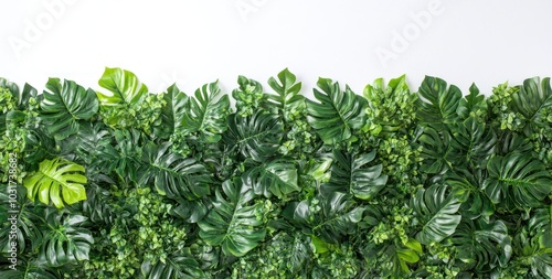 A lush green wall of artificial leaves for decoration or backdrop purposes.