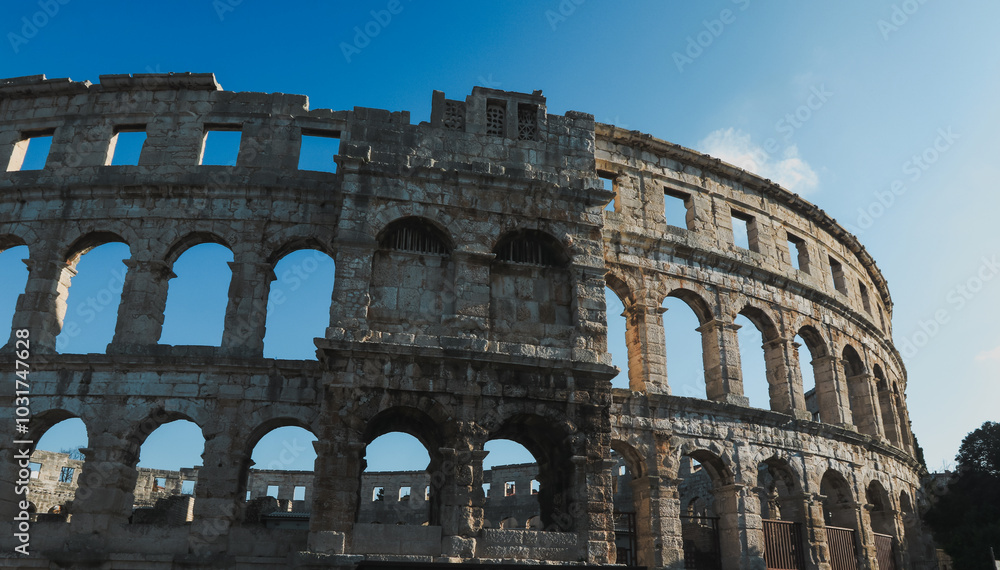 Obraz premium Exploring the ancient Roman amphitheater in Pula Croatia on a sunny day showcasing its impressive architecture and historical significance
