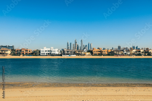 Scenic view of Dubai beachfront highlighting modern architecture and calm waters on a bright sunny day