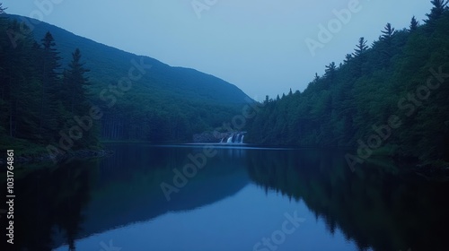 Serene Waterfall Reflecting in a Tranquil Forest Lake at Dusk