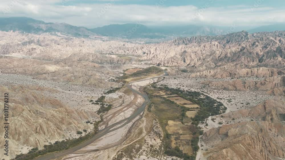Drone view over the Quebrada de las Flechas, featuring a bridge spanning Route 40 in Salta, Argentina, showcasing the stunning rock formations and the surrounding arid landscape. Drone view over the Quebrada de las Flechas, featuring a bridge spanning Route 40 in Salta, Argentina, showcasing the stunning rock formations and the surrounding arid landscape.