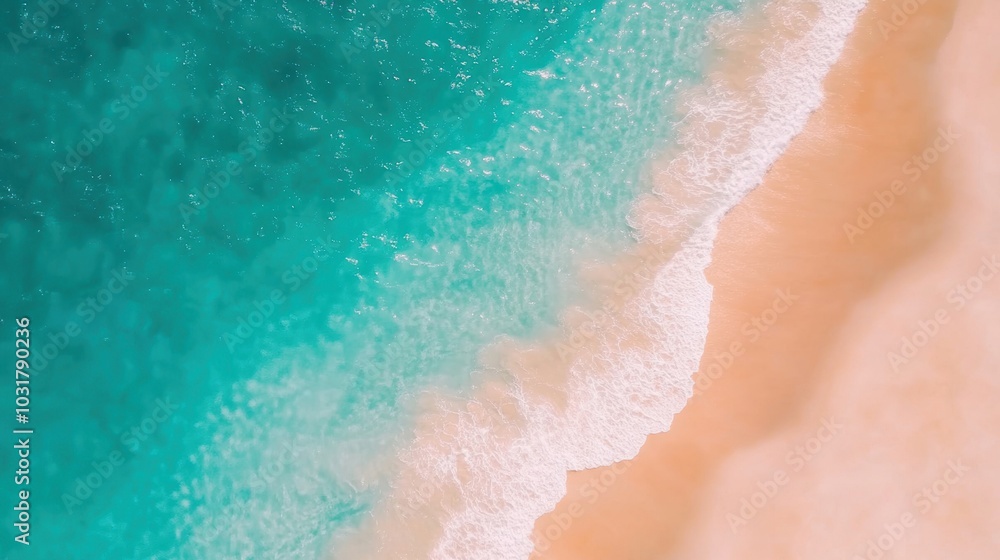 Fototapeta premium Waves crash softly on golden sand, creating a serene atmosphere at a pristine beach under clear blue skies