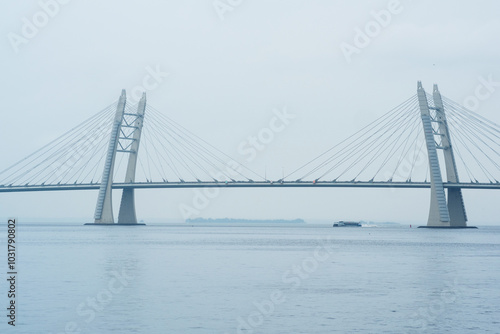 distant bridge over foggy bay on rainy day photo