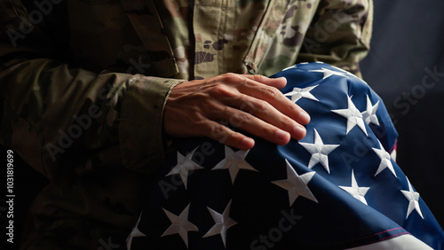 Soldier caressing the stars of a usa Flag on veterans day
