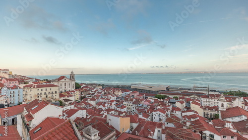 Panorama showing aerial view of Alfama in Lisbon timelapse during sunset. photo