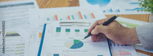 Banner woman working office desk reading financial report finance chart graph on table. Wide tax audit woman hands working paperwork office. Banner Businesswoman Audit financial with copy space