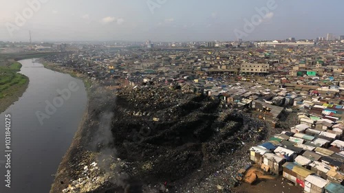 Ghana, Accra,   AGBOGBLOSHIE drone view Odaw River the largest landfill illegal dump in Africa for electronic and plastic waste from the Western world. mountain of toxic waste, environmental disaster 