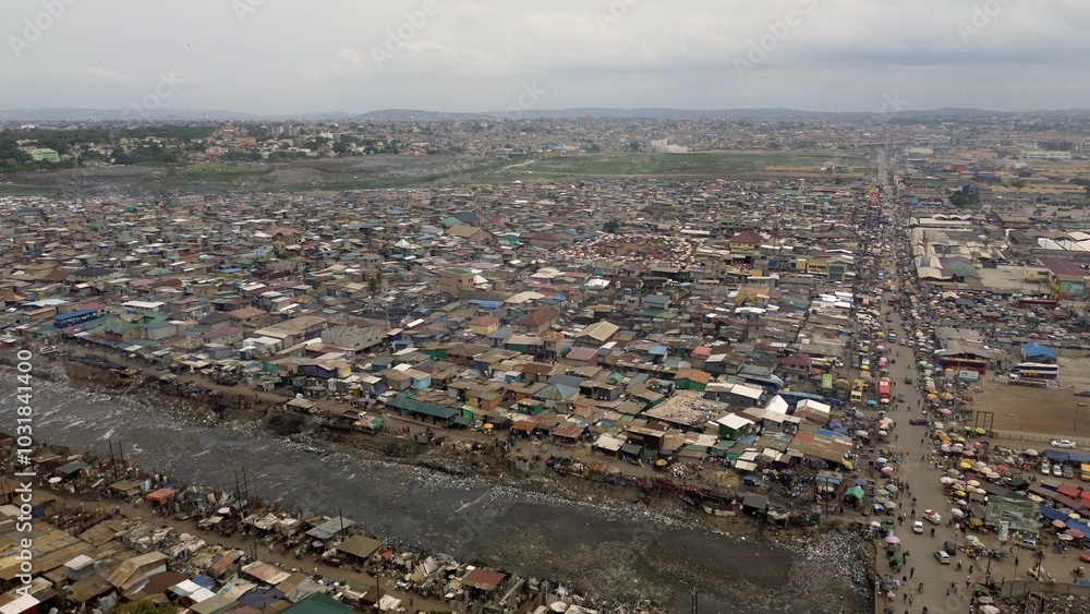 People live in slums immersed immersed in toxic waste that poisons the land and river waters in Africa Africa Ghana AGBOGBLOSHIE. high environmental pollution area , Climate change global warming