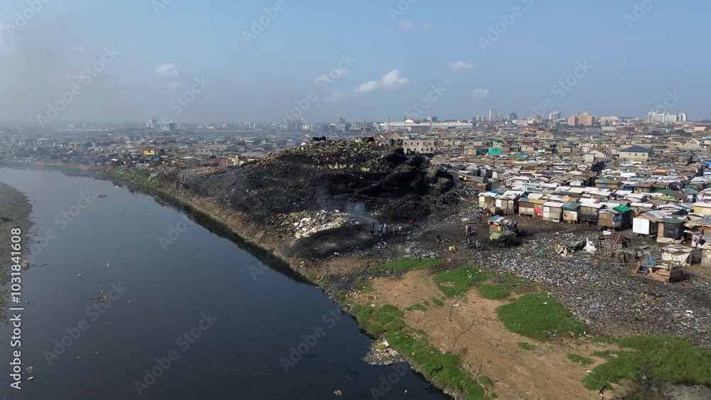 Ghana, Accra, AGBOGBLOSHIE drone view Odaw River the largest landfill illegal dump in Africa for electronic and plastic waste from the Western world. mountain of toxic waste, environmental disaster