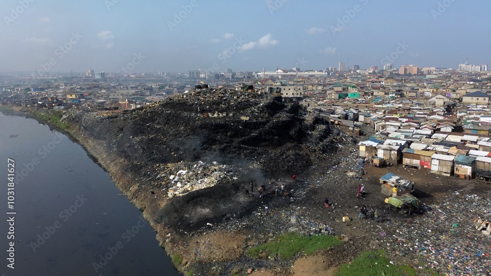 Ghana, Accra, AGBOGBLOSHIE drone view Odaw River the largest landfill illegal dump in Africa for electronic and plastic waste from the Western world. mountain of toxic waste, environmental disaster