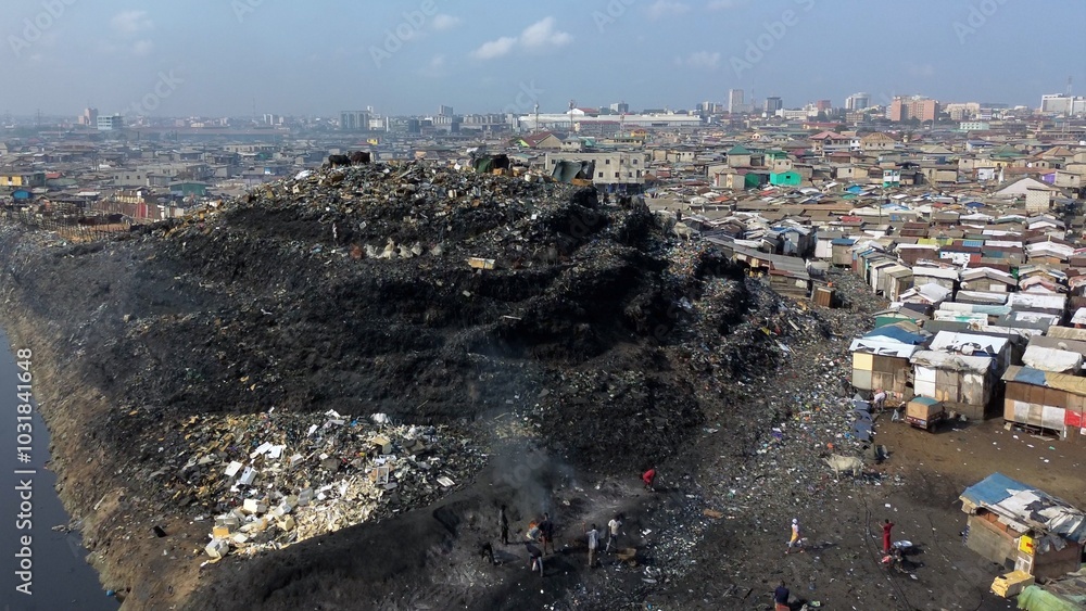 Ghana, Accra, AGBOGBLOSHIE drone view Odaw River the largest landfill illegal dump in Africa for electronic and plastic waste from the Western world. mountain of toxic waste, environmental disaster