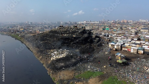 Obraz na płótnie Ghana, Accra, AGBOGBLOSHIE drone view Odaw River the largest landfill illegal dump in Africa for electronic and plastic waste from the Western world. mountain of toxic waste, environmental disaster w salonie