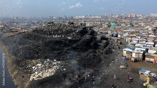Obraz na płótnie Ghana, Accra, AGBOGBLOSHIE drone view Odaw River the largest landfill illegal dump in Africa for electronic and plastic waste from the Western world. mountain of toxic waste, environmental disaster w salonie