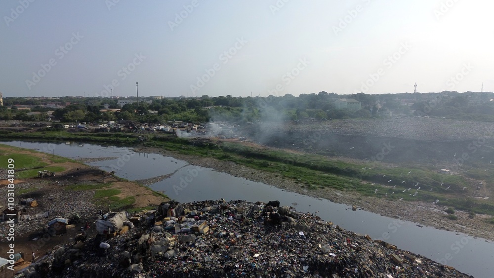 Ghana, Accra, AGBOGBLOSHIE drone view Odaw River the largest landfill illegal dump in Africa for electronic and plastic waste from the Western world. mountain of toxic waste, environmental disaster