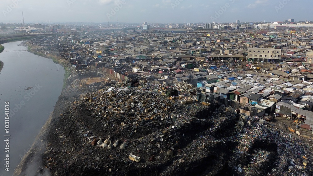 Ghana, Accra, AGBOGBLOSHIE drone view Odaw River the largest landfill illegal dump in Africa for electronic and plastic waste from the Western world. mountain of toxic waste, environmental disaster