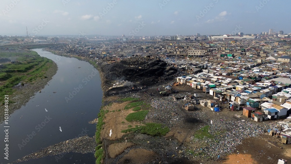 Ghana, Accra, AGBOGBLOSHIE drone view Odaw River the largest landfill illegal dump in Africa for electronic and plastic waste from the Western world. mountain of toxic waste, environmental disaster