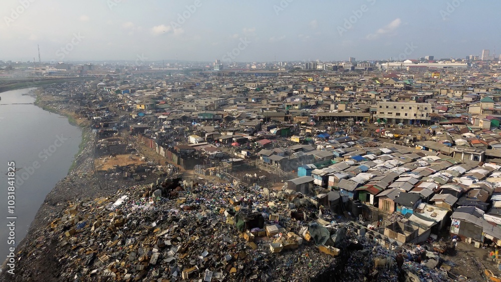 People live in slums immersed immersed in toxic waste that poisons the land and river waters in Africa Africa Ghana AGBOGBLOSHIE. high environmental pollution area , Climate change global warming