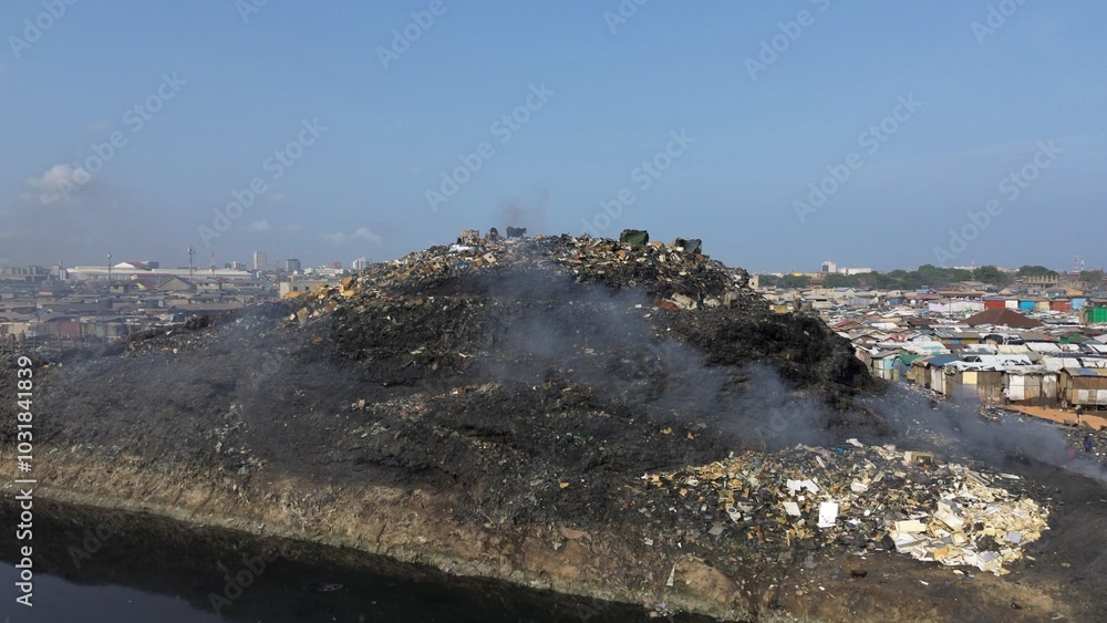 Ghana, Accra, AGBOGBLOSHIE drone view Odaw River the largest landfill illegal dump in Africa for electronic and plastic waste from the Western world. mountain of toxic waste, environmental disaster