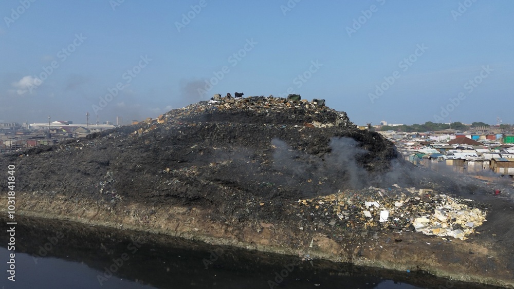 Ghana, Accra, AGBOGBLOSHIE drone view Odaw River the largest landfill illegal dump in Africa for electronic and plastic waste from the Western world. mountain of toxic waste, environmental disaster
