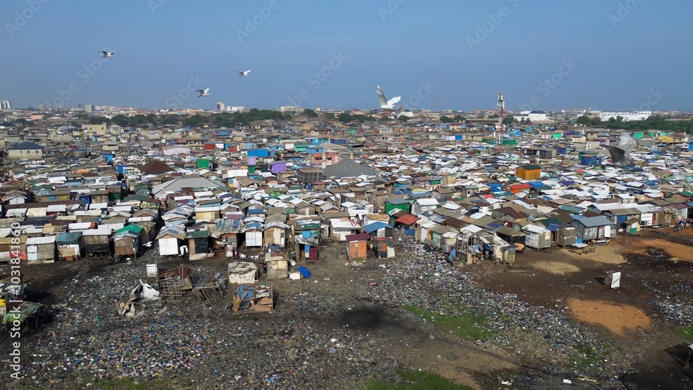 People live in slums immersed immersed in toxic waste that poisons the land and river waters in Africa Africa Ghana AGBOGBLOSHIE. high environmental pollution area , Climate change global warming