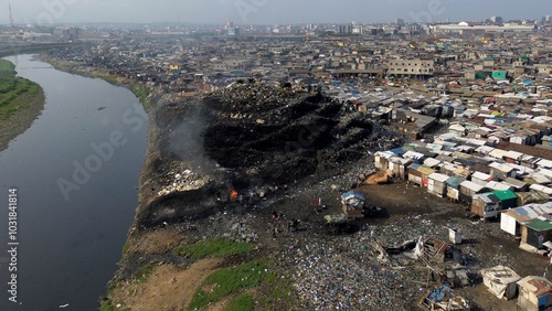 Ghana, Accra,   AGBOGBLOSHIE drone view Odaw River the largest landfill illegal dump in Africa for electronic and plastic waste from the Western world. mountain of toxic waste, environmental disaster 