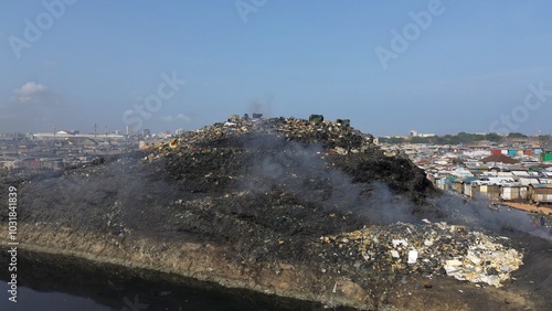 Obraz na płótnie Ghana, Accra, AGBOGBLOSHIE drone view Odaw River the largest landfill illegal dump in Africa for electronic and plastic waste from the Western world. mountain of toxic waste, environmental disaster w salonie