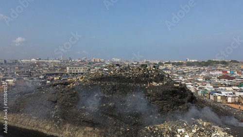 Ghana, Accra,   AGBOGBLOSHIE drone view Odaw River the largest landfill illegal dump in Africa for electronic and plastic waste from the Western world. mountain of toxic waste, environmental disaster  photo