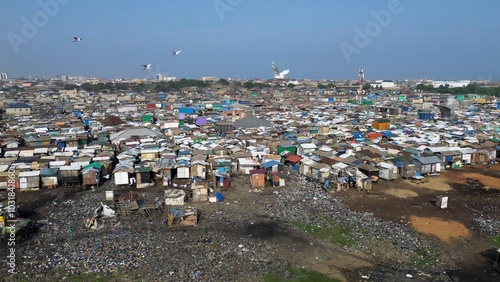 Obraz na płótnie People live in slums immersed immersed in toxic waste that poisons the land and river waters in Africa Africa Ghana AGBOGBLOSHIE. high environmental pollution area , Climate change global warming w salonie
