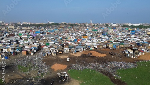 Obraz na płótnie People live in slums immersed immersed in toxic waste that poisons the land and river waters in Africa Africa Ghana AGBOGBLOSHIE. high environmental pollution area , Climate change global warming w salonie