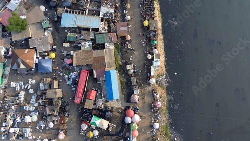 Obraz na płótnie People live in slums immersed immersed in toxic waste that poisons the land and river waters in Africa Africa Ghana AGBOGBLOSHIE. high environmental pollution area , Climate change global warming w salonie