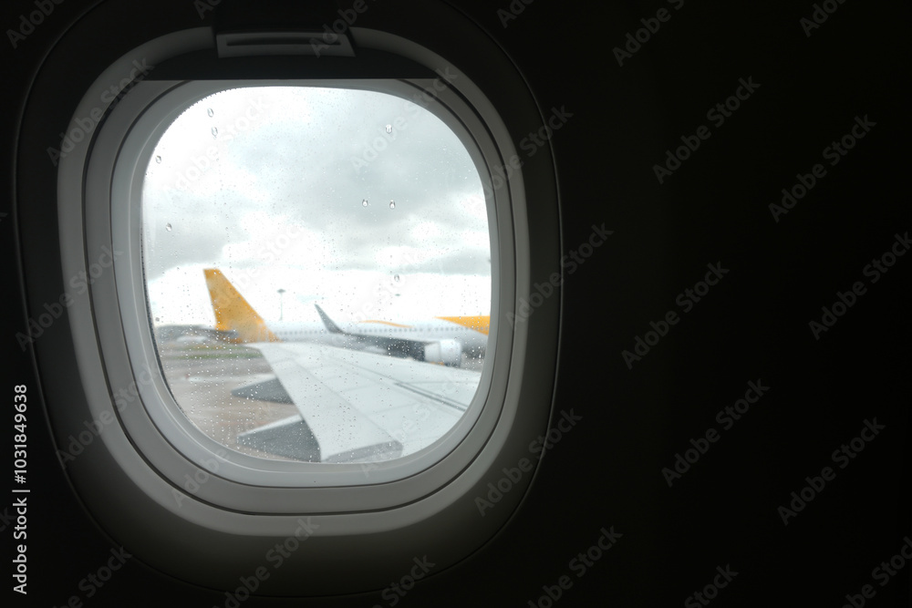 View From The Plane Window Of A Parked Plane At The Airport Terminal With Copy Space View From The Plane Window Of A Parked Plane At The Airport Terminal With Copy Space
