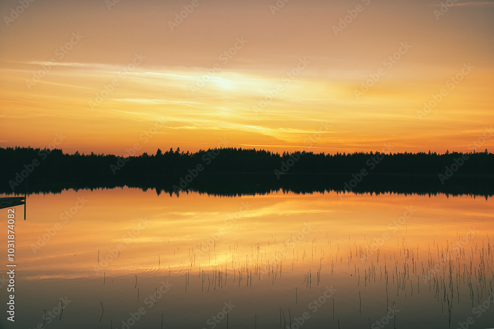 Sunset with warm colors on a Swedish lake in Smalland. Romantic evening atmosphere Sunset with warm colors on a Swedish lake in Smalland. Romantic evening atmosphere