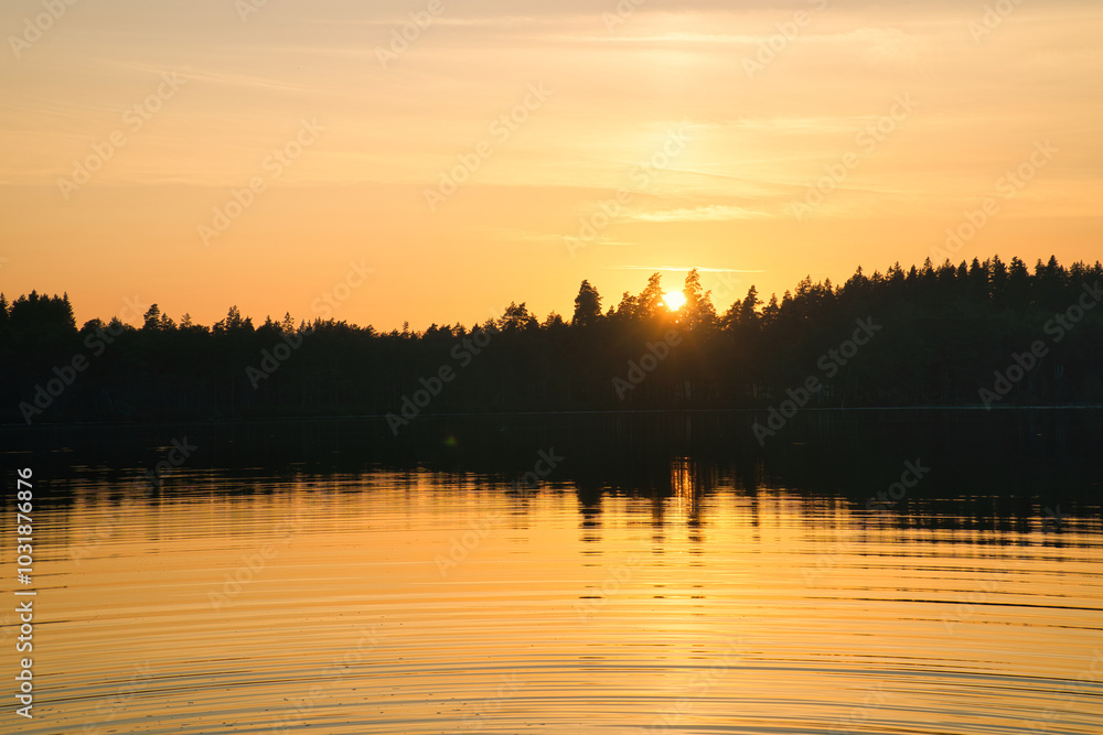 Obraz premium Sunset with warm colors on a Swedish lake in Smalland. Romantic evening atmosphere