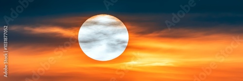  A vibrant orange-blue sky with a white disc at its center and a dark orange cloud situated therein
