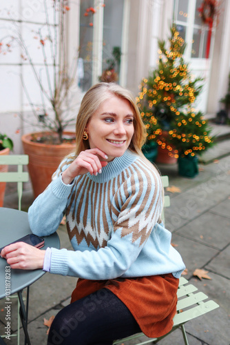 Portrait of beautiful attractive smiling slavic girl enjoying holiday Christmas market, Winter, snowy day, festive city new year atmosphere