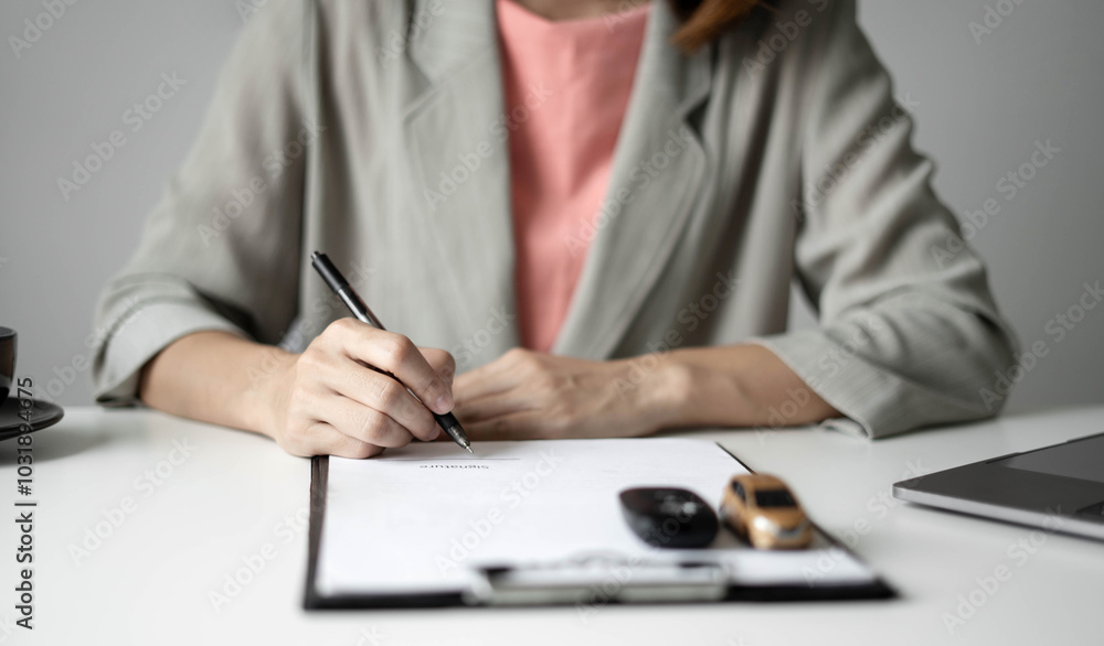 Car dealer businessWoman signing car insurance document or lease paper. Car loan and insurance concept Car dealer businessWoman signing car insurance document or lease paper. Car loan and insurance concept