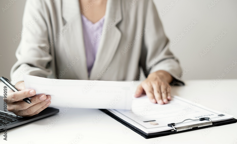 Business woman employer holding resume hiring recruit looking cv resume to hire candidates, analyzing information before job interview. Recruitment concepts Business woman employer holding resume hiring recruit looking cv resume to hire candidates, analyzing information before job interview. Recruitment concepts